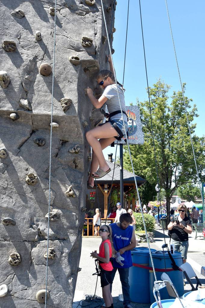 The rock-climbing wall at the Block Party drew a steady stream of adventurers Saturday. Carol Ladwig/Staff Photo