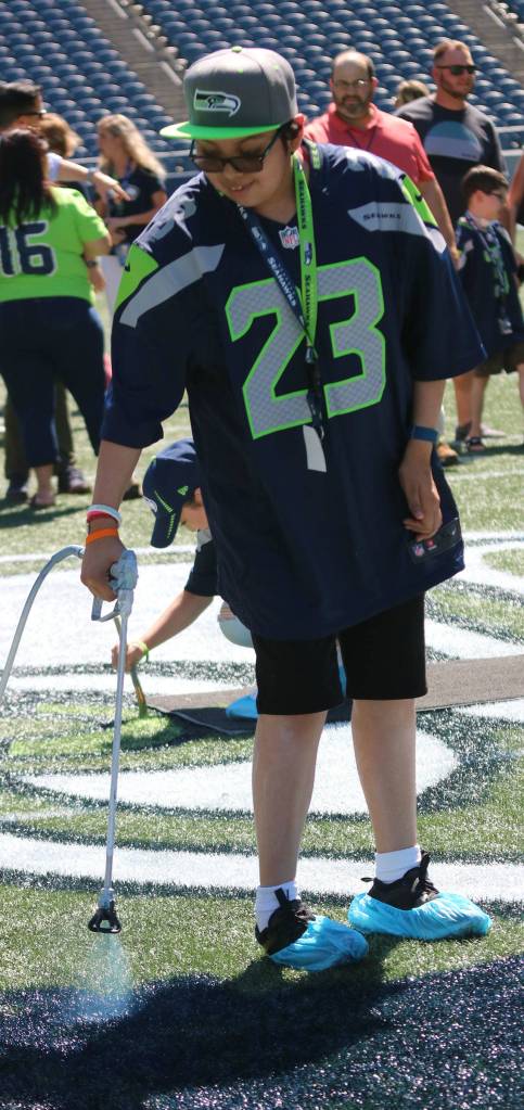 Joaquin helps paint the field for the Seahawks versus Indianapolis Colts preseason game. Andy Nystrom / staff photo