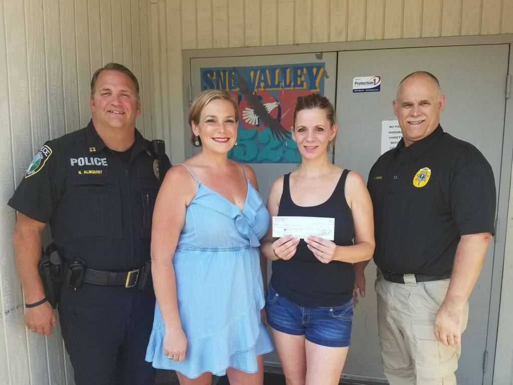 From left: Captain Nick Almquist, Gini Ekoes, Heather Payne, and Chief Perry Phipps. Courtesy photo.