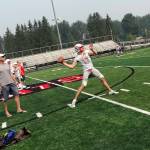 Mount Si Wildcats senior quarterback Cale Millen, center, unleashes pass deep down the right sideline on the first day of practice on Aug. 15. Millen will play college football at the University of Oregon next year. Shaun Scott/staff photo