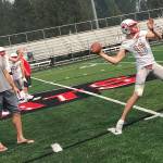 Mount Si Wildcats senior quarterback Cale Millen, center, unleashes pass deep down the right sideline on the first day of practice on Aug. 15. Millen will play college football at the University of Oregon next year. Shaun Scott/staff photo