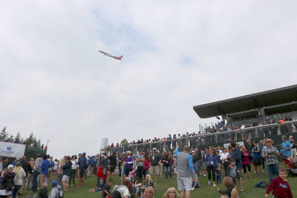 The crowd looks around to spot the Boeing plane flying above them. Evan Pappas/Staff Photo