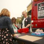 Maggie Wong, public services librarian for the King County Library System, talks with kids at the librarys booth. (Joe Dockery/Courtesy Photo)