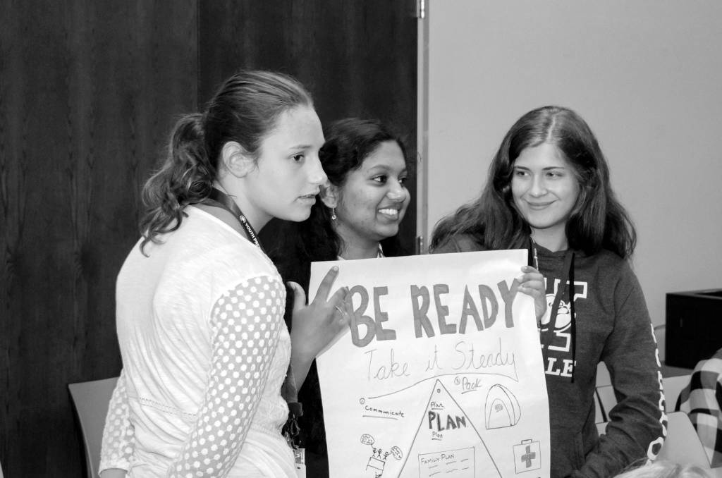 (Right to left) Gabrielle Karber, Ritusha Samal and Teagan Grabish show off the disaster preparedness poster their group developed as part of a short activity at FEMA. Photo courtesy of FEMA Region 10, Jeffrey Markham