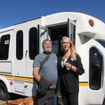 Snoqualmie Valley Transportation supporter David Egan and Director Amy Biggs stand together in front of one of the busses. Evan Pappas/Staff Photo