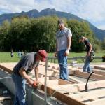 SVYAC board member Byron Moore works with other volunteers on one of the walls. Evan Pappas/Staff Photo