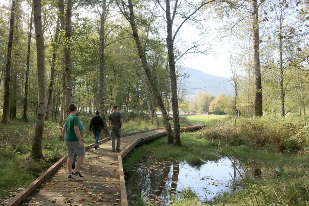 A bridge crafted by Eagle Scouts leads from the street-side open space of the property to the more heavily forested area. Evan Pappas/Staff Photo