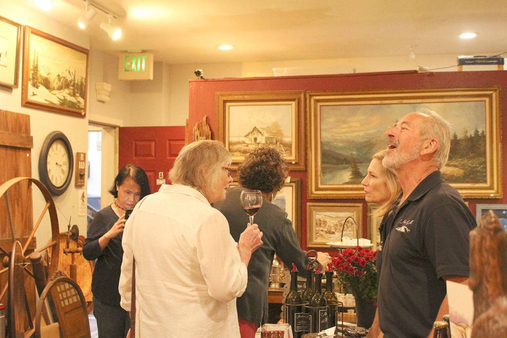 Locals taste wine in various shops throughout Finally Friday Art and Wine Walk. Madison Miller/staff photo.