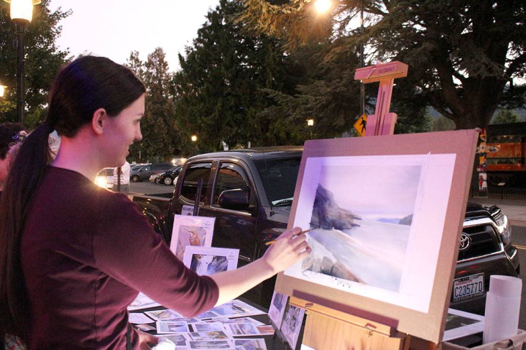 Jacqueline Tribble paints watercolor landscapes by flashlight. Madison Miller/staff photo.