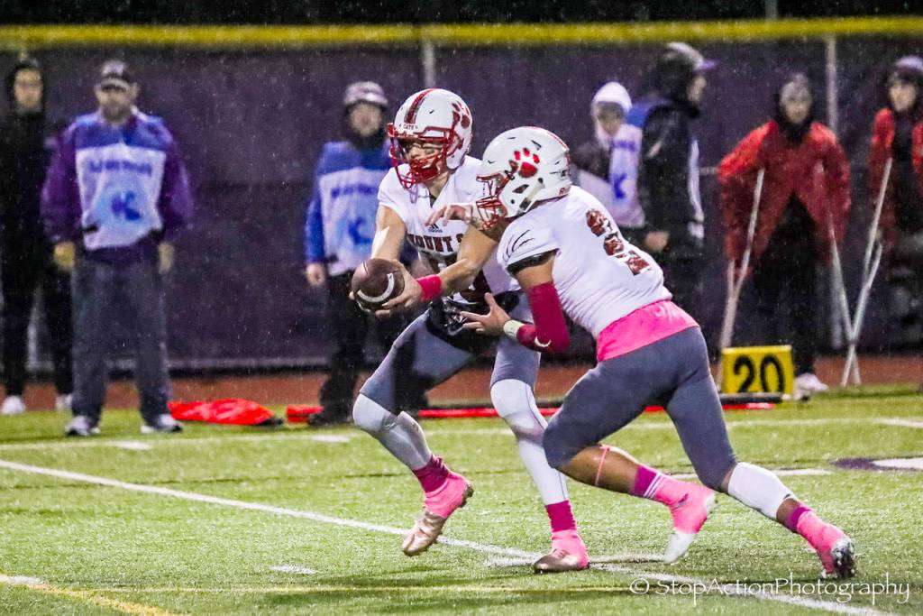 Mount Si Wildcats senior quarterback Cale Millen, left, hands off to running back Cole Norah in the first half of play. Norah had three rushing touchdowns in Mount Sis 38-6 victory against Issaquah on Oct. 5 at Gary Moore Stadium in Issaquah. Photo courtesy of Don Borin/Stop Action Photography