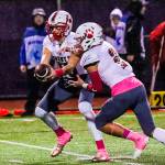 Mount Si Wildcats senior quarterback Cale Millen, left, hands off to running back Cole Norah in the first half of play. Norah had three rushing touchdowns in Mount Sis 38-6 victory against Issaquah on Oct. 5 at Gary Moore Stadium in Issaquah. Photo courtesy of Don Borin/Stop Action Photography