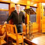 Executive Director Richard Anderson stands inside Chapel Car 5 next to the newly installed pews and the replaced lectern. Evan Pappas/Staff Photo