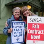 Ingrid Garhart of SVSD (left) and Shannon Smith of Snoqualmie Elementary (right) pose for a photo while picketing at the street corner of City Hall for a fair contract for district secretaries. Madison Miller/staff photo.