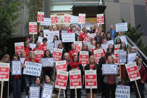 SVSD teachers, secretaries, SVEA and PSE members, and other supporters picket in front of Snoqualmie Valley City Hall before the Oct. 23 school board meeting for living wages of district secretaries. Madison Miller/staff photo.