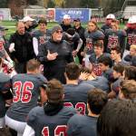 Mount Si Wildcats head football coach Charlie Kinnune, center, addresses his players following their convincing 42-0 victory against the Rogers Rams in a winner-to-state, loser-out playoff game on Nov. 3 in Snoqualmie. Shaun Scott/staff photo