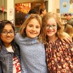 Ms. Cuddihys fourth-grade class hosts veterans at the schools Veterans Day assembly. From left: Maanha Rahman, Aryna Kravtsova and Anna Giles. Madison Miller/staff photo.