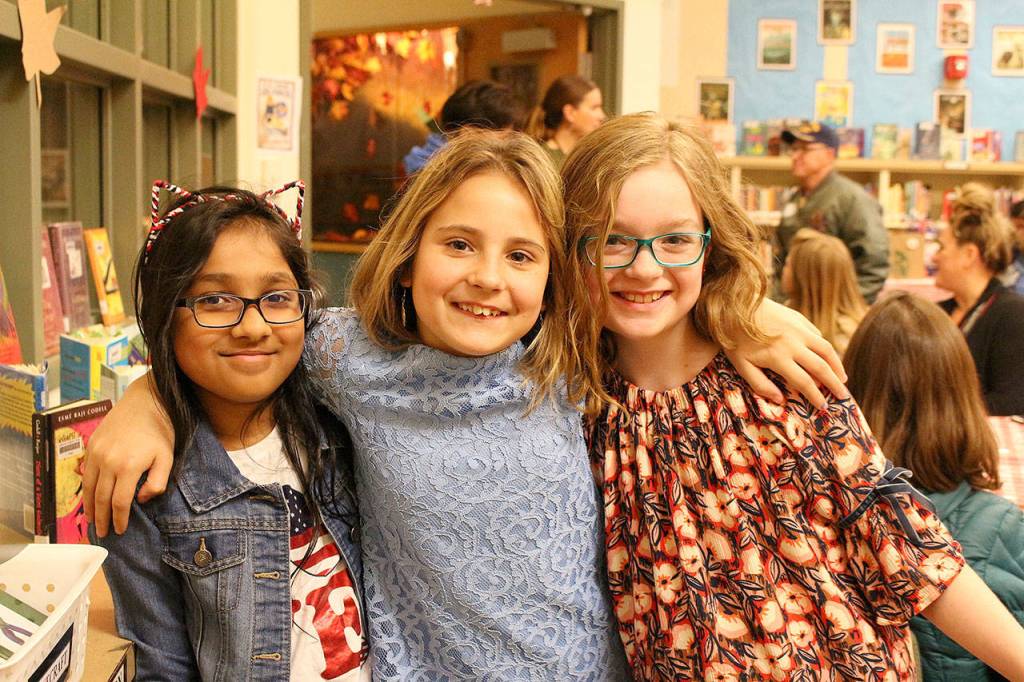 Ms. Cuddihys fourth-grade class hosts veterans at the schools Veterans Day assembly. From left: Maanha Rahman, Aryna Kravtsova and Anna Giles. Madison Miller/staff photo.