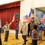 Peter Gabryjelski and other fourth-grade students from Ms. Cuddihys class welcome veterans as they enter the Snoqualmie Elementary Veterans Day assembly on Nov. 9. Madison Miller/staff photo