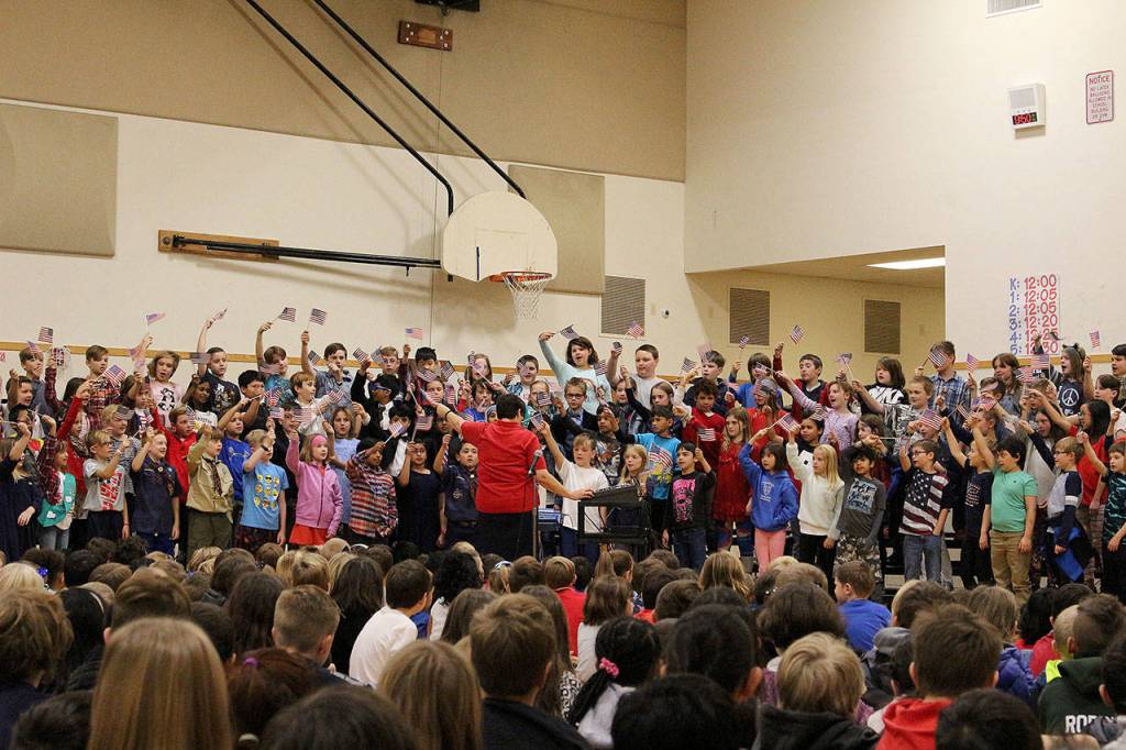 Ms. Cuddihys fourth grade class sing patriotic songs at Snoqualmie Elementarys Veterans Day assembly. Madison Miller/staff photo.