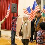 Peter Gabryjelski and other fourth-grade students from Ms. Cuddihys class welcome veterans as they enter the Snoqualmie Elementary Veterans Day assembly on Nov. 9. Madison Miller/staff photo