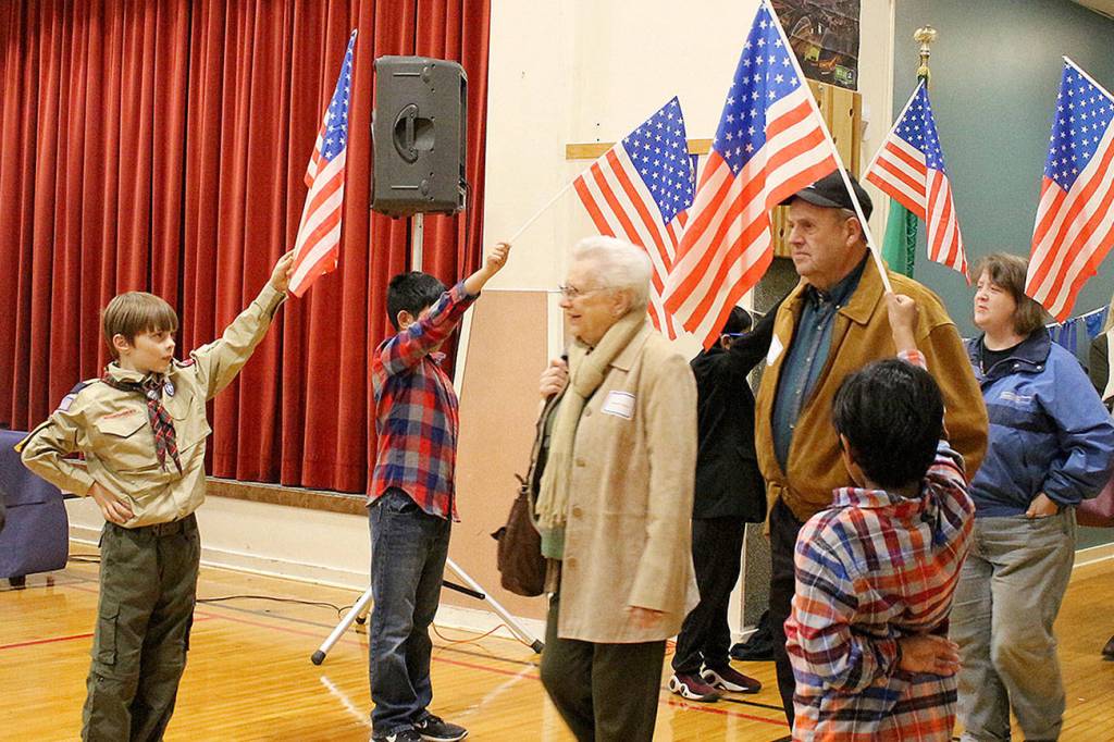 Peter Gabryjelski and other fourth-grade students from Ms. Cuddihys class welcome veterans as they enter the Snoqualmie Elementary Veterans Day assembly on Nov. 9. Madison Miller/staff photo