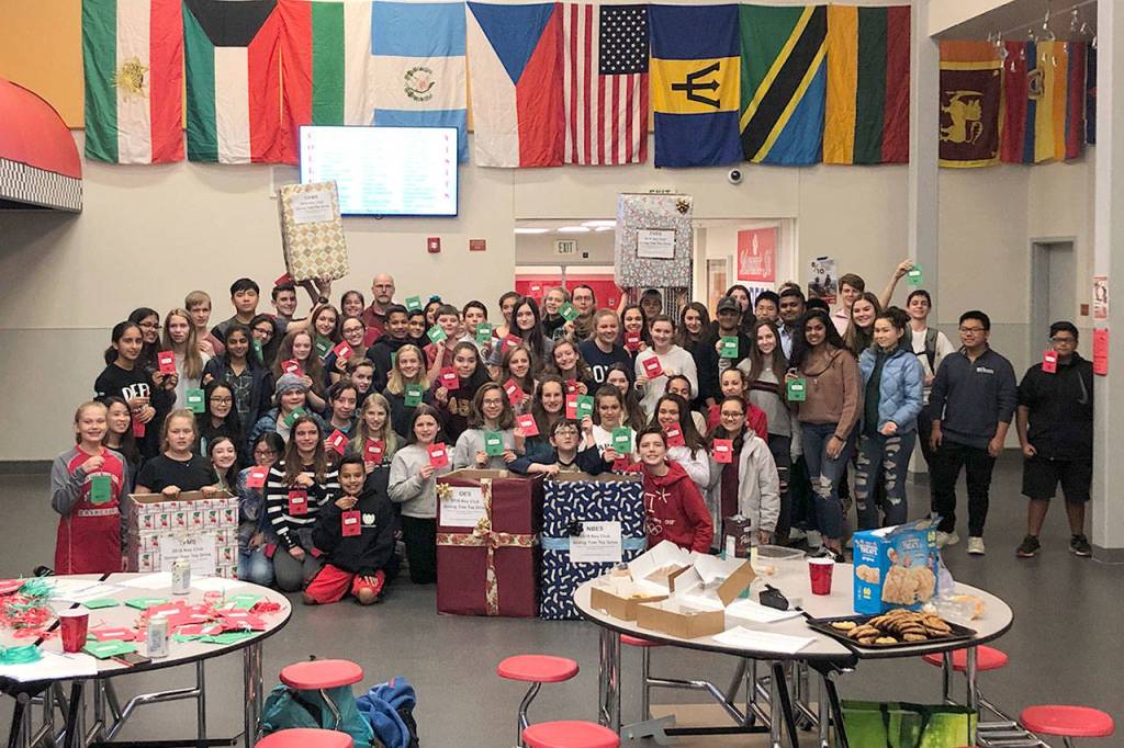 The Mount Si Key Club, Twin Falls Builders Club, and Two Rivers Key Club work together to craft the gift tags that will hang on the Giving Trees around the Valley this holiday season. Courtesy Photo