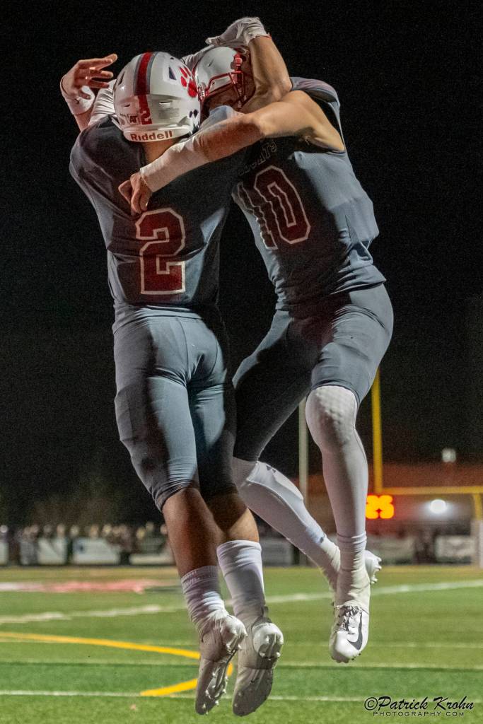Mount Si Wildcats senior quarterback Cale Millen (No. 10) and sophomore running back Cole Norah (No.2) celebrate after Norah scored on a 5-yard touchdown run with 8:02 left in regulation, cutting Puyallups lead to 33-28. Patrick Krohn/Patrick Krohn Photography