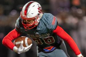 Mount Si Wildcats senior wide receiver Jonny Barrett (pictured) tries to escape a tackle from Puyallup defensive back Kyler Johnson. Puyallup defeated Mount Si 47-34 in the Class 4A state quarterfinals. Photo courtesy of Patrick Krohn/Patrick Krohn Photography