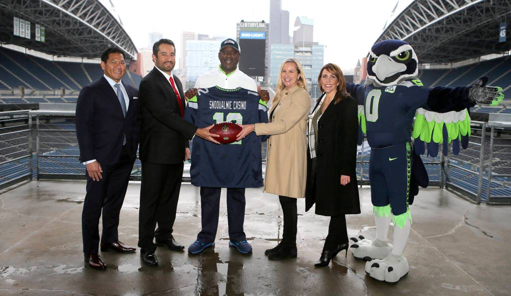 Snoqualmie Casino and the Seattle Seahawks officially form advertising partnership. From left: Casino chief marketing officer Stanford Le, Casino CEO Brian Decorah, former Seahawks player Randall Morris, Seahawks senior VP of revenue Amy Sprangers, and director of sales and corporate partnerships Gina Martinez Todd. Courtesy Photo