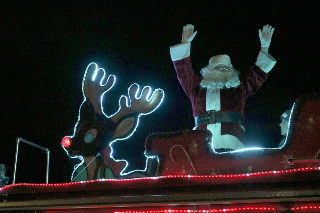 Santa rides into North Bend on an Eastside Fire and Rescue fire engine. Evan Pappas/Staff Photo