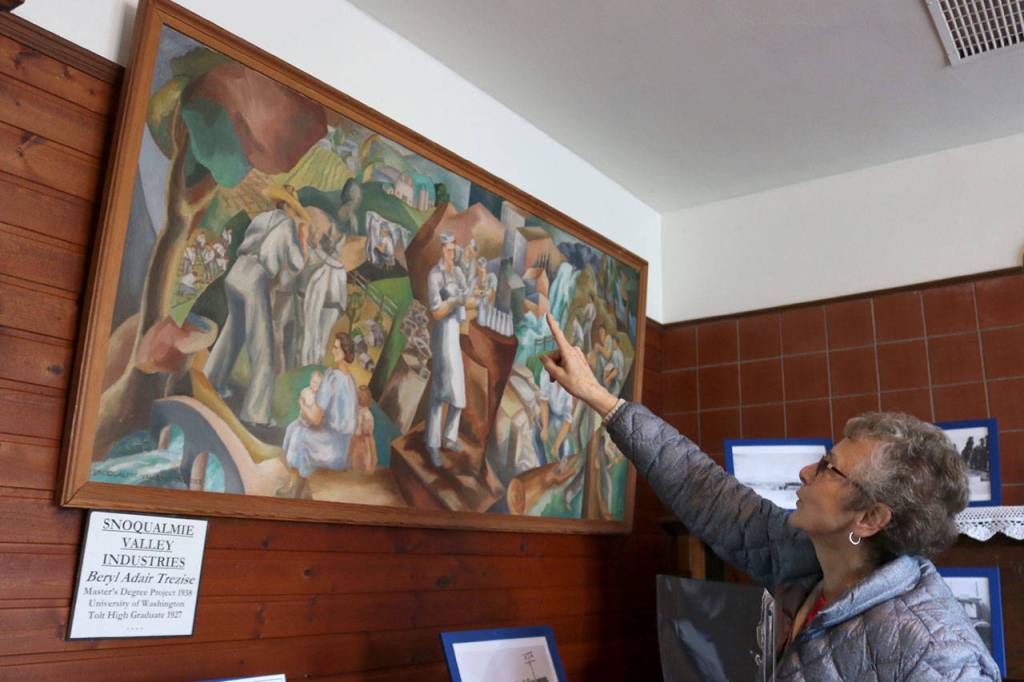 Tolt Historical Society member Jackie Norris explains the history behind the 1938 painting Snoqualmie Valley Industries by Beryl Adair Trezise. Evan Pappas/Staff Photo