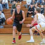 Mount Si junior guard Jabe Mullins, left, surveys the court while being defended by Newport senior Thomas Kristen. Mount Si defeated Newport, 66-44, on Dec. 14 at Newport High School in Factoria. Mullins scored 18 points in the win. Photo courtesy of Patrick Krohn/Patrick Krohn Photography