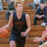 Mount Si junior guard Jabe Mullins, left, surveys the court while being defended by Newport senior Thomas Kristen. Mount Si defeated Newport, 66-44, on Dec. 14 at Newport High School in Factoria. Mullins scored 18 points in the win. Photo courtesy of Patrick Krohn/Patrick Krohn Photography