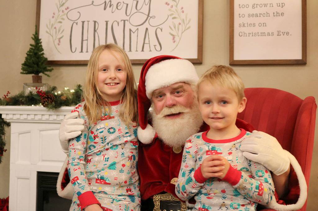 Samantha and Tyson Patty meet Santa Claus at the Snoqualmie Candy Shoppe on Dec. 15. Evan Pappas/Staff Photo