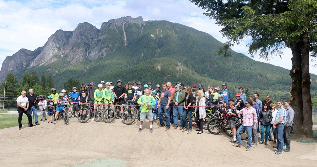 City Staff, Si View Metro Parks staff, volunteers, and bikers gather to officially cut the ribbon on the bike track at Torguson Park. Evan Pappas/Staff Photo