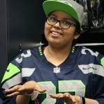 North Bends Paola Joaquin talks with family members in front of her personalized locker at CenturyLink Field in Seattle on Aug. 7. Andy Nystrom/Staff Photo