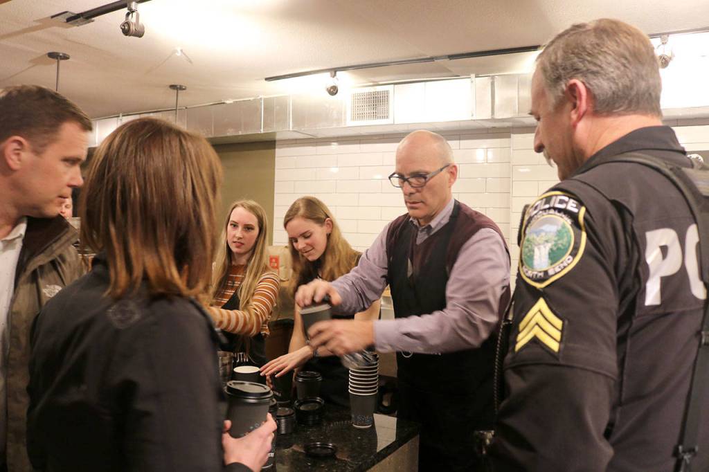 Volunteers serve coffee to community members as the film crew prepares to surprise the Trail Youth owners. Evan Pappas/Staff Photo