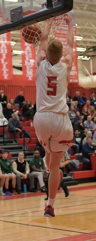 Mount Si junior Jabe Mullins finishes off a slam dunk against Skyline. Photo courtesy of Calder Productions