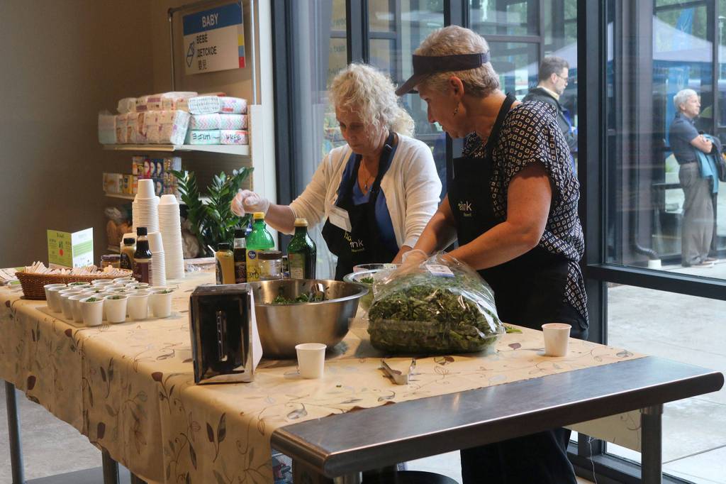 Hopelink volunteers host a cooking demonstration in the Redmond food bank on Aug. 3. The organization recently received a $822,500 grant from Premera. Katie Metzger/staff photo