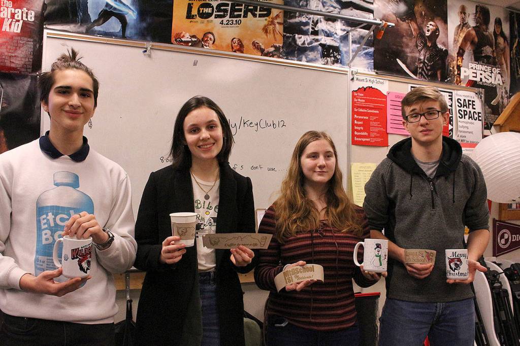 From left: Maximo Jimenez, Cameron McCrea, Rowen Higgins and Ivan Dyshlevich. Joe Dockerys digital media class create and sell coffee mugs and sleeves to support the schools suicide prevention program. Madison Miller/staff photo