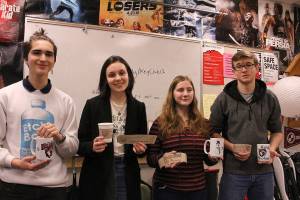 From left: Maximo Jimenez, Cameron McCrea, Rowen Higgins and Ivan Dyshlevich. Joe Dockerys digital media class create and sell coffee mugs and sleeves to support the schools suicide prevention program. Madison Miller/staff photo