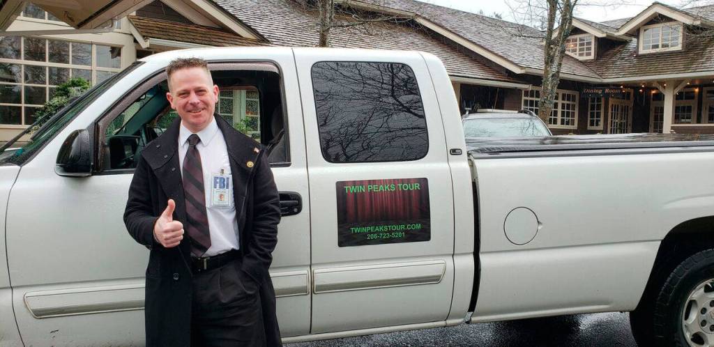 David Israel commits to his guided tours by getting into costume and playing music from Twin Peaks for those on his tour (Drew Stuart/Staff Photo)