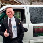 David Israel commits to his guided tours by getting into costume and playing music from Twin Peaks for those on his tour (Drew Stuart/Staff Photo)