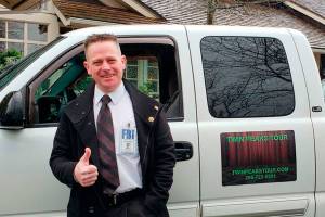David Israel commits to his guided tours by getting into costume and playing music from Twin Peaks for those on his tour (Drew Stuart/Staff Photo)