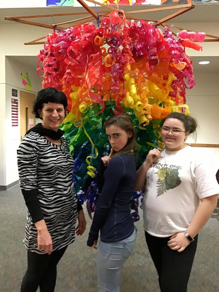 Julie Lagace poses with eighth grade students, Nicole Alexander and Grace Carnes, with the completed chandelier. Photos courtesy of Julie Lagace