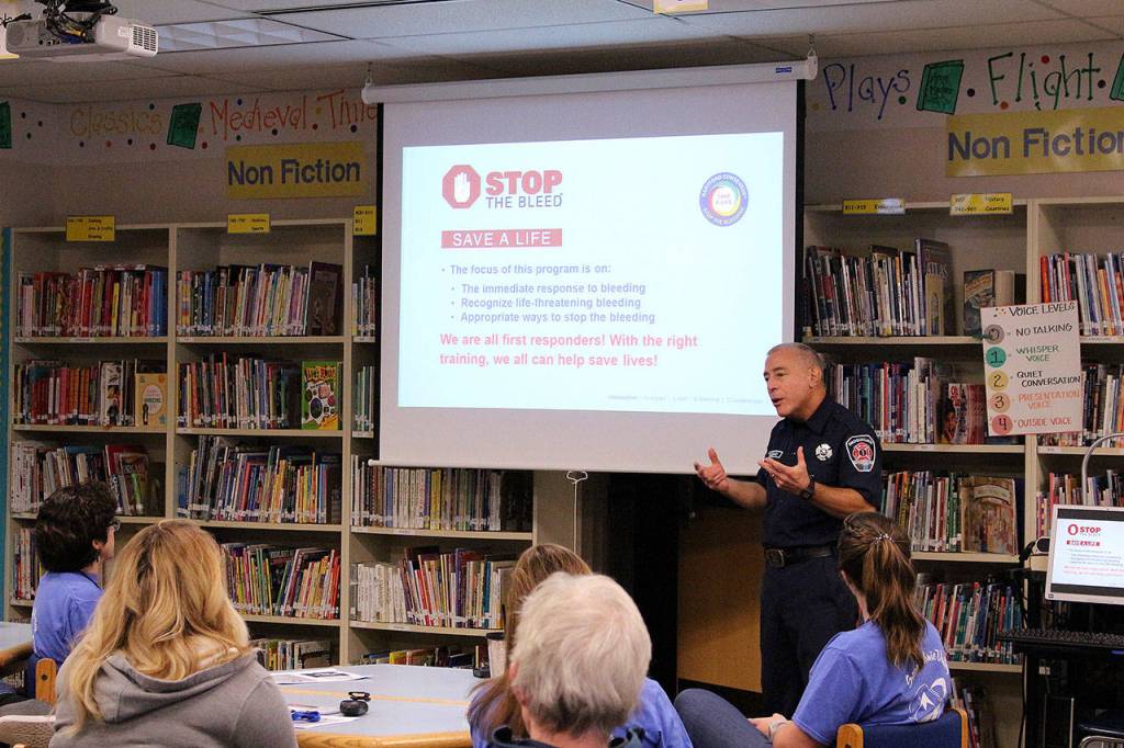 Snoqualmie Fire Dept. Lt. Robert Angrisano shares ways to stop uncontrollable bleeding in case of a school shooting or natural disaster with Opstad Elementary teachers and staff. Madison Miller/staff photo.