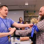 Opstad Elementary Schools principal Ryan Hill and math teacher Ryan Vidos practice using tourniquets as part of the Stop the Bleeds training. Madison Miller/staff photo.