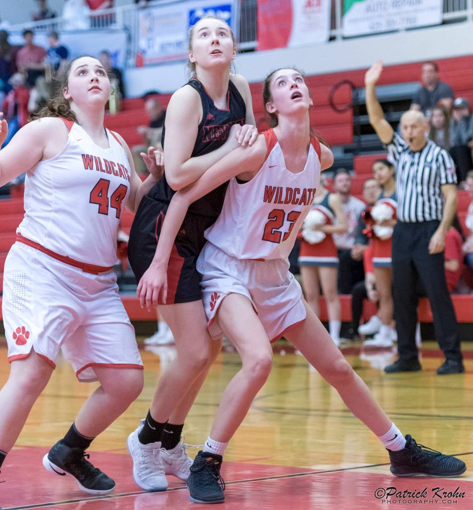 Mount Si Wildcats freshman Lauren Glazier, right, and senior Abigail Triou, left, box out a Newport player during a matchup on senior night on Jan. 16 in Snoqualmie. Photo courtesy of Patrick Krohn/Patrick Krohn Photography