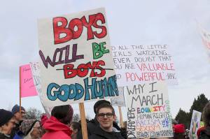 Young boy carries a sign that reads, Boys will be good humans. Stephanie Quiroz/staff photo.