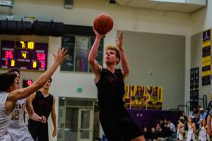 Mount Si Wildcats junior guard Jabe Mullins takes the ball to the hoop in the fourth quarter against the Issaquah Eagles. Mount Si defeated Issaquah 74-49 on Jan. 25 at Issaquah High School. Photo courtesy of Don Borin/Stop Action Photography